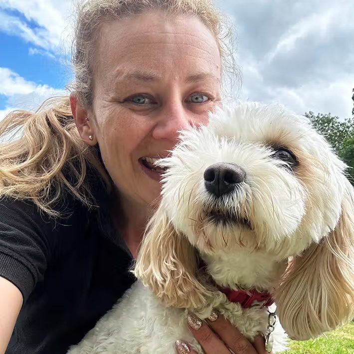 Inside Zara's 6-acre facility Zara's team member cuddling a happy cockapoo at the day care centre